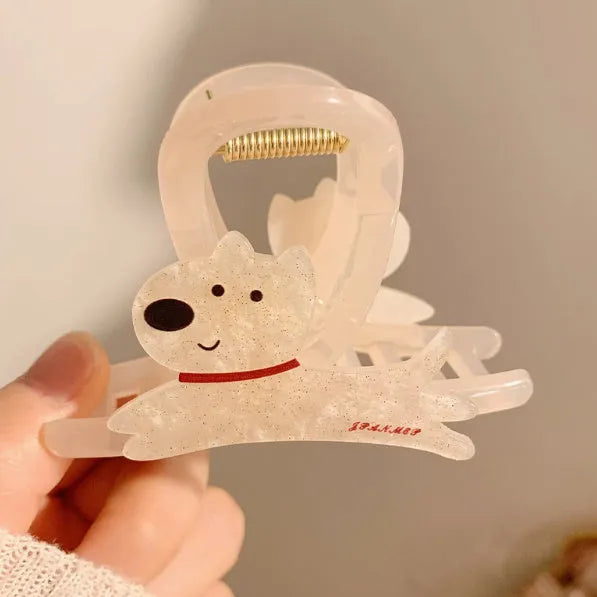 Cartoon puppy design hair barrette clip in beige and brown colours on a white background.