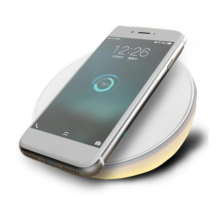 White wireless phone charger with clock display and control buttons on front