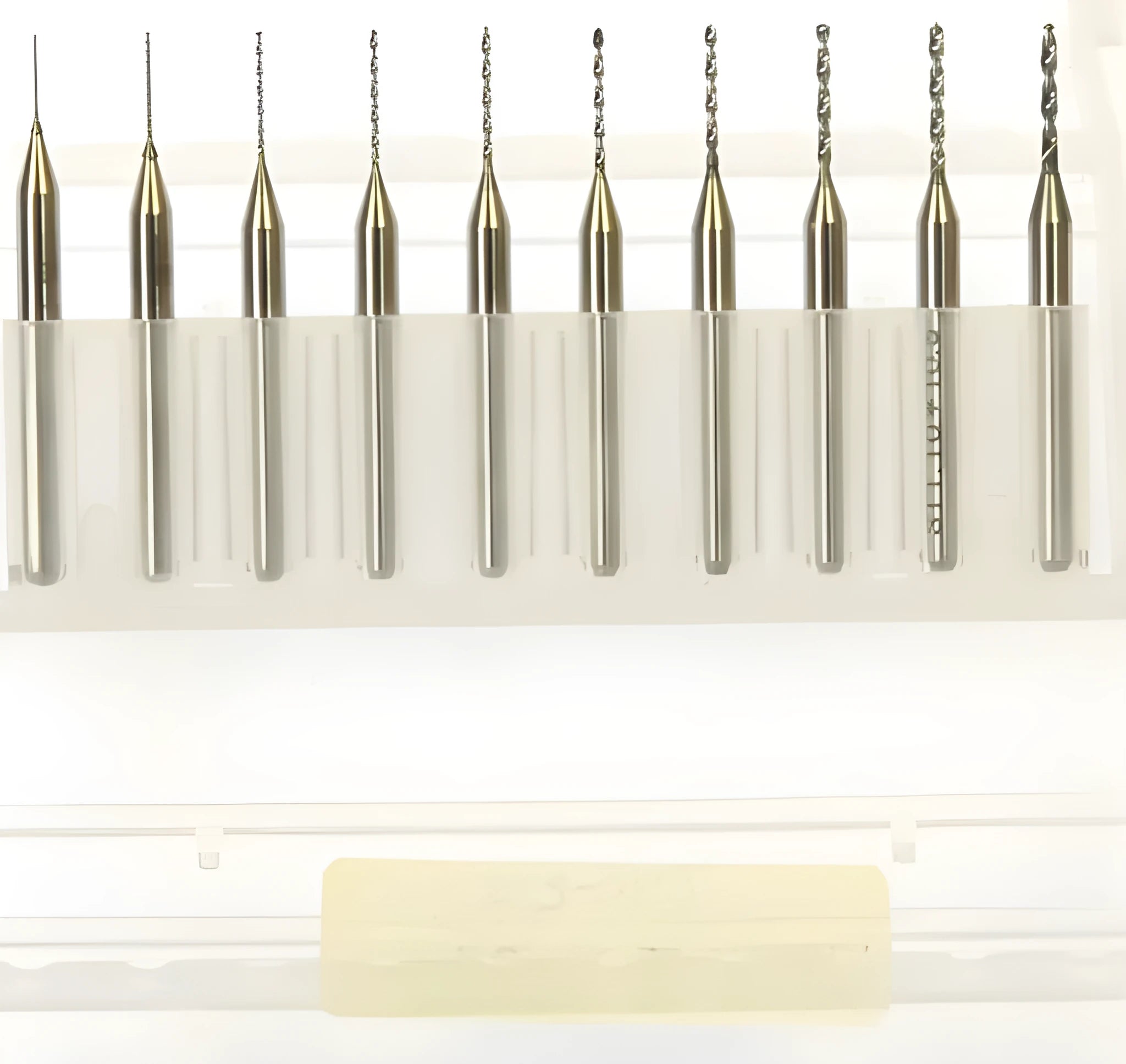 Close-up of a set of imported tungsten carbide micro-engraving bits in various sizes from 0.10mm to 2.00mm diameter.