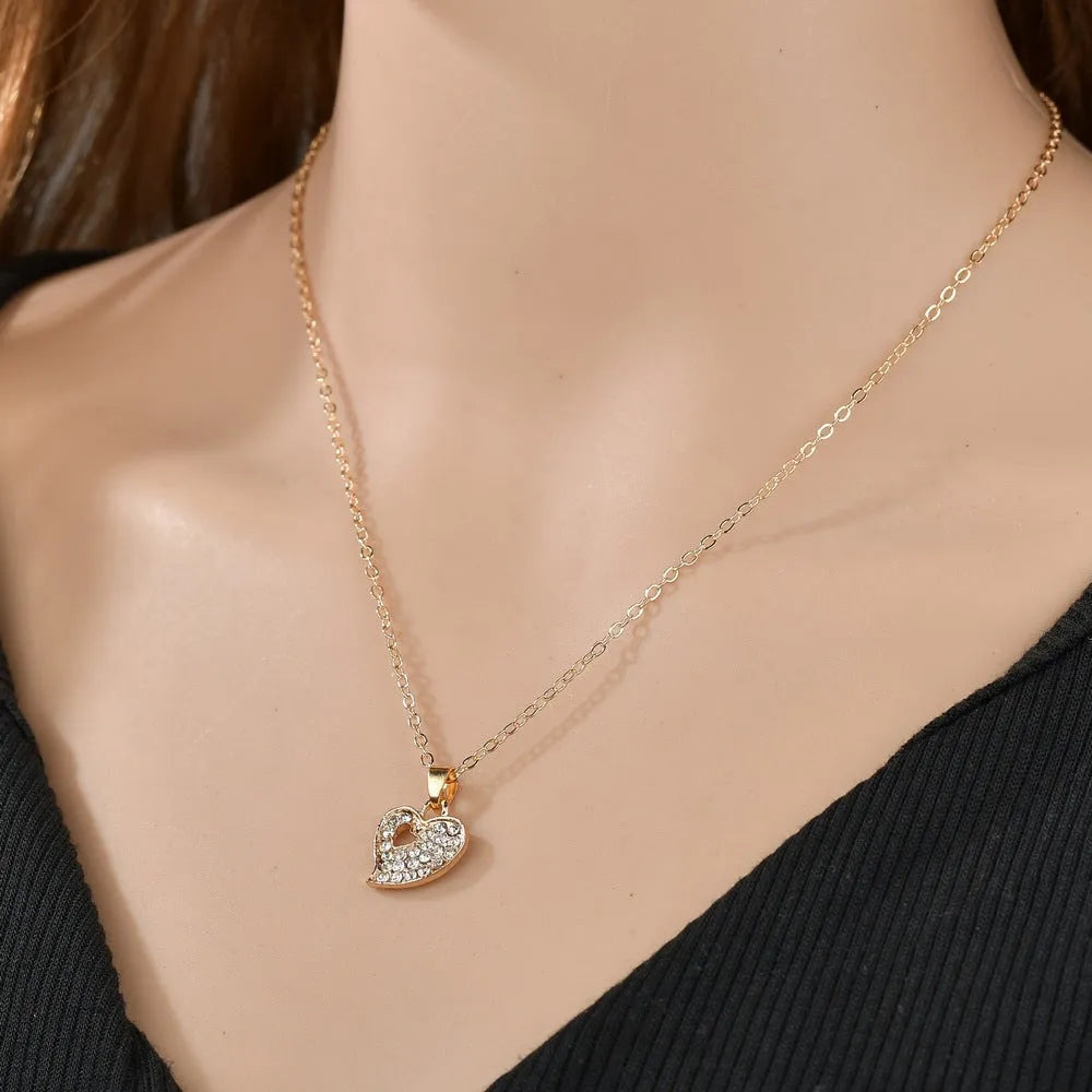 Gold electroplated women's jewellery set with love, water drop and bell pendants on adjustable chain