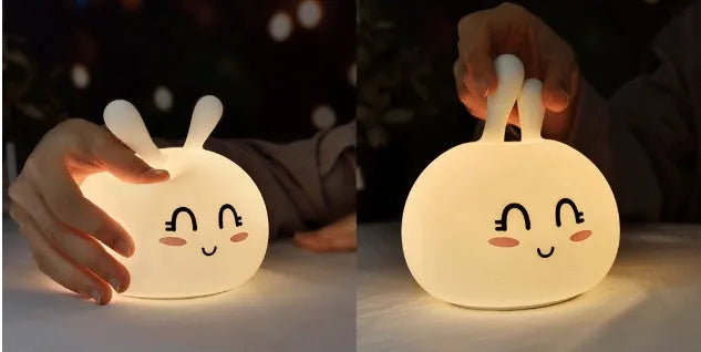 Marshmallow Bunny LED Night Light with 0.4W ABS silicone construction and happy face expression on a bedside table