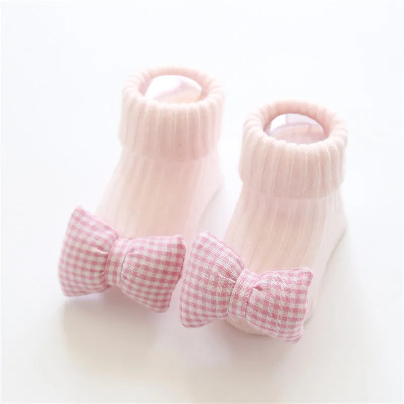 Cotton baby floor socks in various colours and patterns including bows, stars, and animal designs