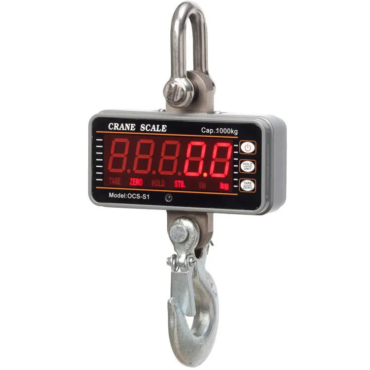 Orange electronic crane scale with digital display, showing a weight readout, hooked to a chain for lifting.