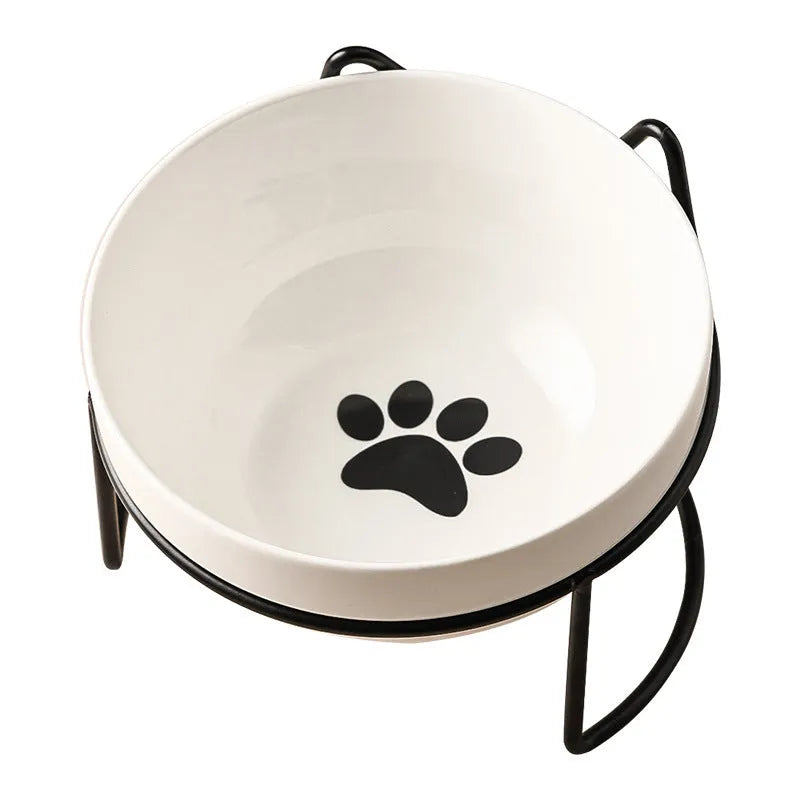 White ceramic cat bowl with paw print design in a black iron cat-ear frame.