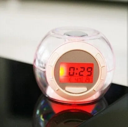 White colourful natural sound alarm clock with LCD display showing time and temperature