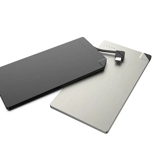 Ultra-slim silver graphene battery power bank 4000mAh on surface with cables