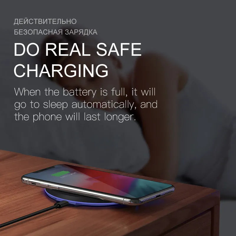 10W/5W black fast wireless phone charger pad on desk with iPhone - 100mm diameter, 8mm thick