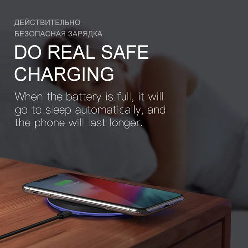 10W/5W black fast wireless phone charger pad on desk with iPhone - 100mm diameter, 8mm thick