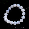 Natural blue moonlight polished round moonstone bead bracelet on a white background.
