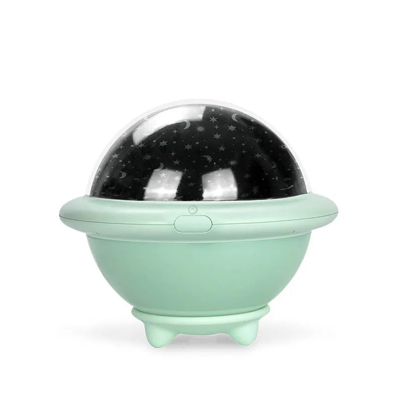 Green UFO-shaped plastic night light projecting a starry sky pattern on a wall.
