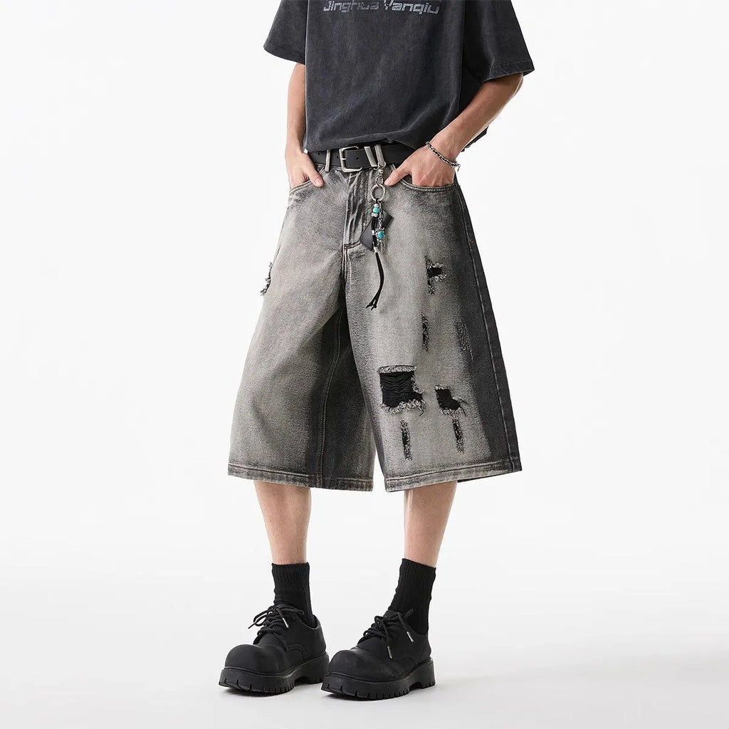 Grey distressed denim shorts with water washed finish and loose retro fit