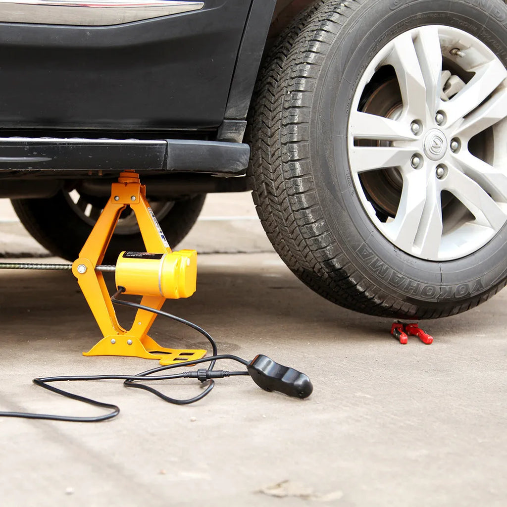 Vehicle-mounted electric hydraulic jack kit with a 2-tonne capacity on a grey background.