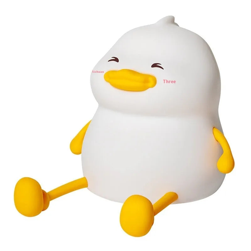 Chubby silicone rechargeable night light on a desk, showing soft glow and touch-sensitive surface.