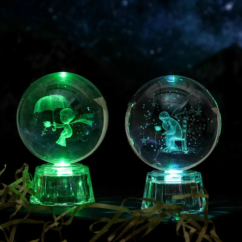 Transparent crystal ball ornament with inner carving on a table, 6cm in diameter with a modern base.