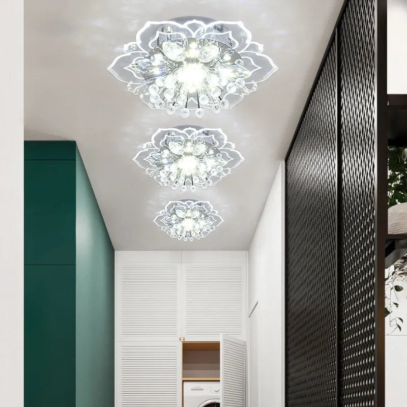 Small modern crystal and acrylic ceiling lamp with stainless steel fitting on a white ceiling.