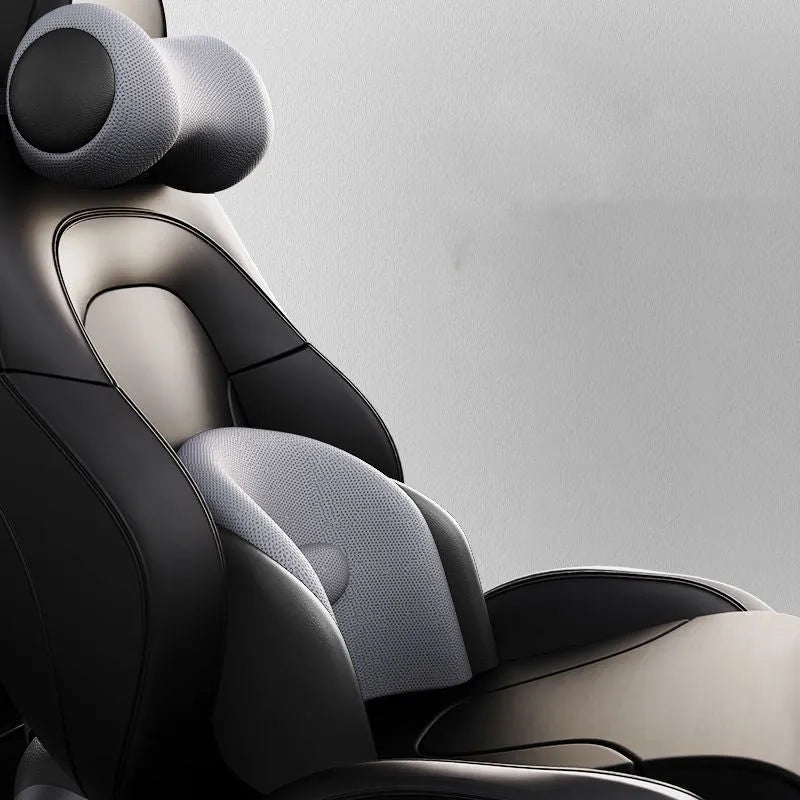 Car seat massage cushion and headrest set made from memory foam in a neutral colour.