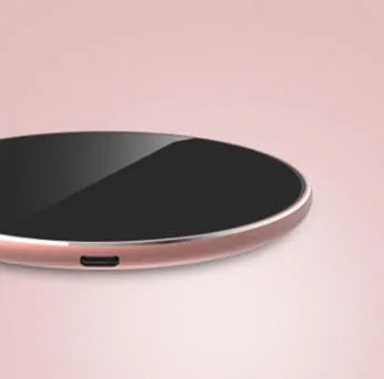 Ultra-thin aluminum wireless charging pad in silver colour on a wooden desk