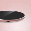 Ultra-thin aluminum wireless charging pad in silver colour on a wooden desk