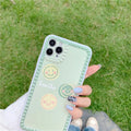 Green iPhone case with geometric pattern and smiley face polka dot design on a soft TPU back cover.