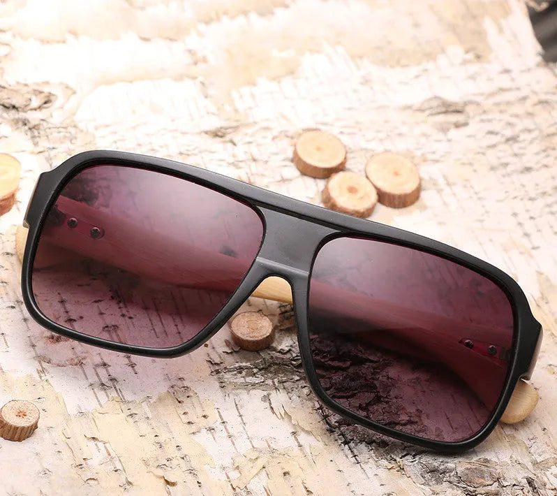 Wooden square sunglasses with brown frame and PC lenses on a flat surface