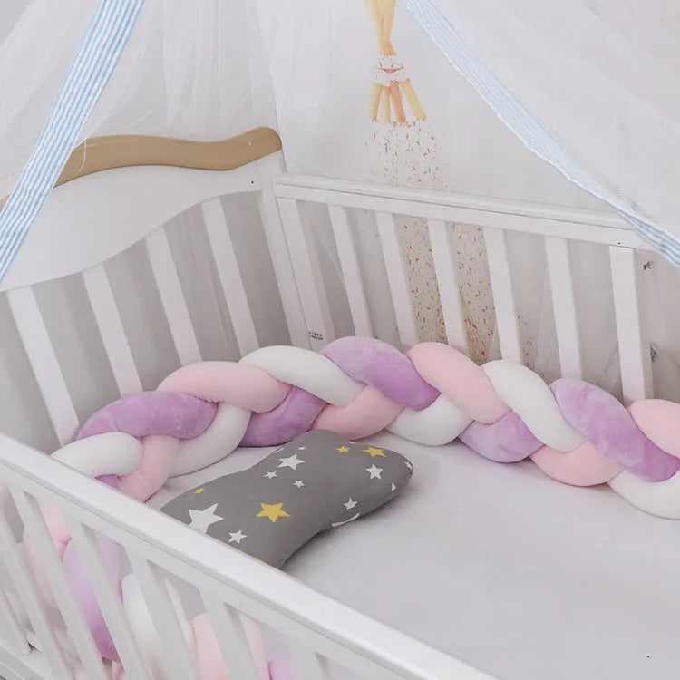 Braided knot style baby cot bumper in spandex crystal velvet fabric, shown in a light grey colour.