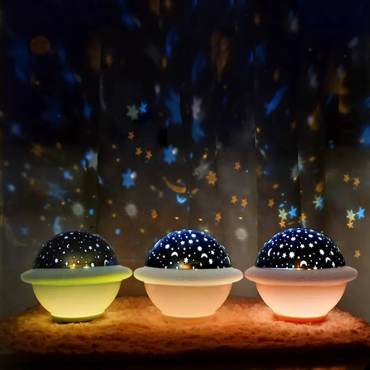 Green UFO-shaped plastic night light projecting a starry sky pattern on a wall.