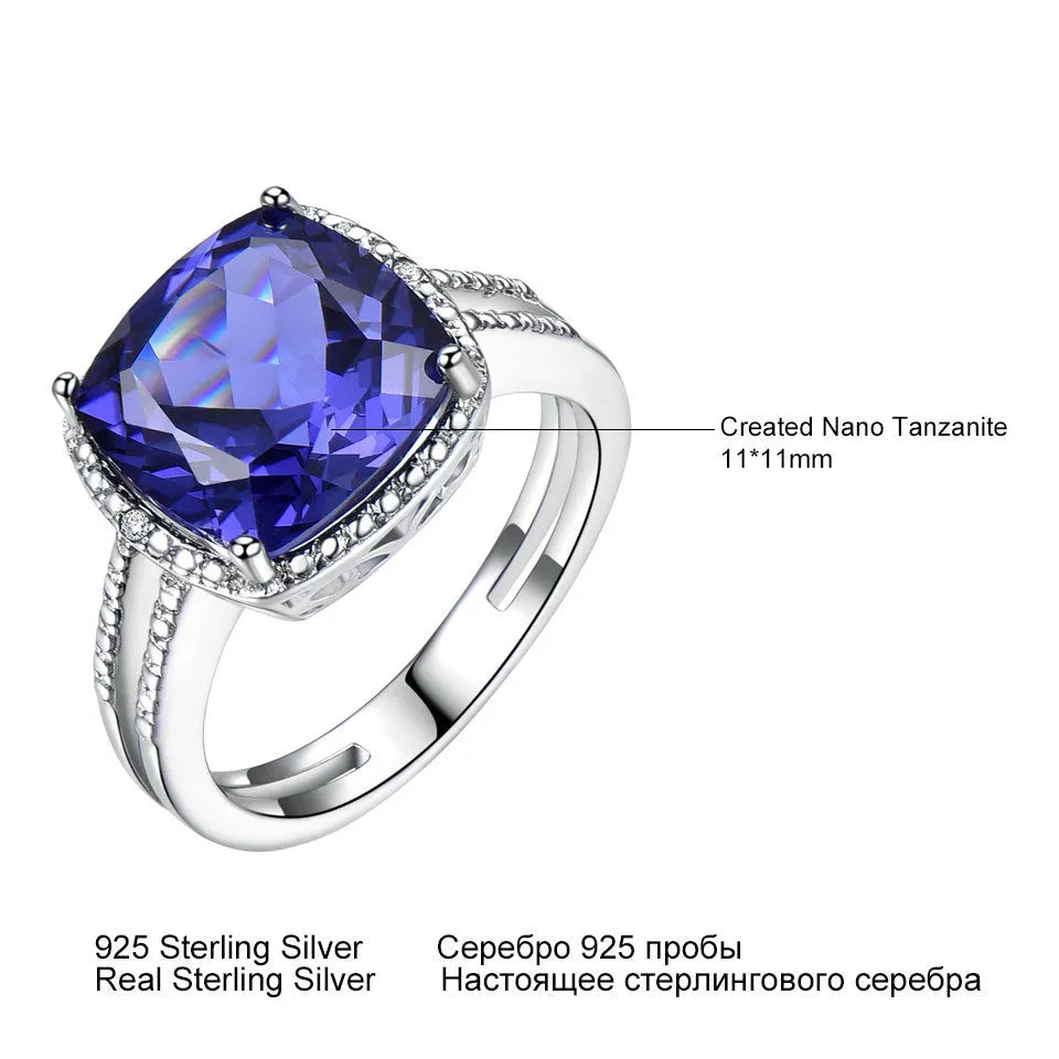 Women's sterling silver ring with a blue tanzanite gemstone on a finger.