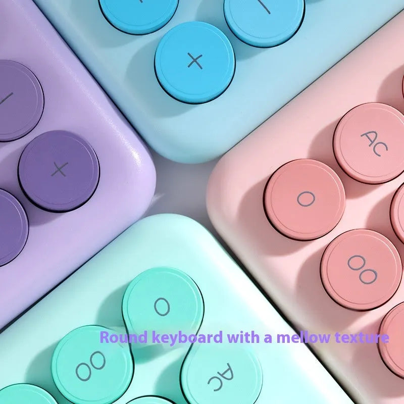 A gradient colour desk calculator on a desk, showing violet, mint green, blue, and pink colour options.