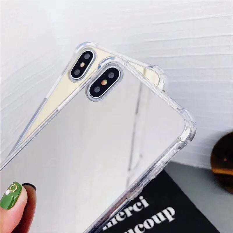 Mirrored front TPU protective case for iPhone in multiple colour options on a table.