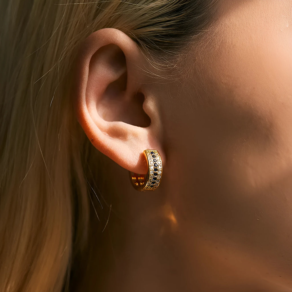 A pair of round, geometric copper earrings with an 18K electroplated gold-colour finish.