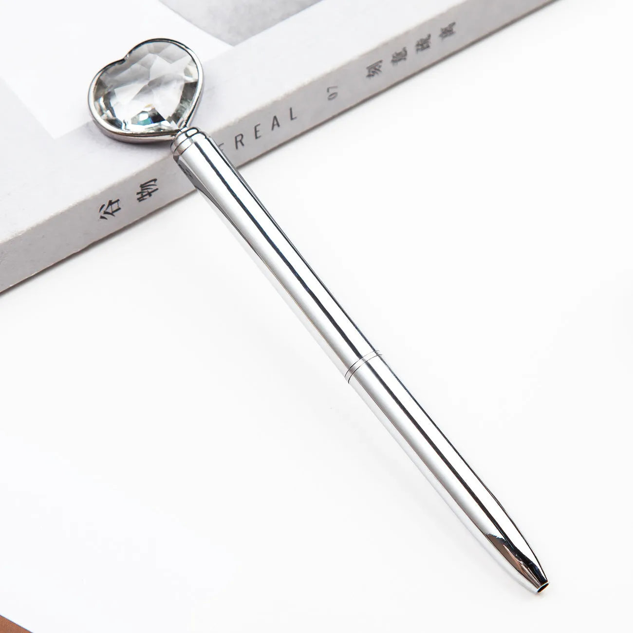 Creative Crystal Love Ball diamond metal pen in rose gold on a white background