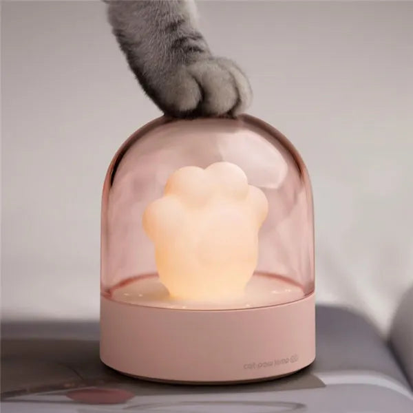 Grey cat paw shaped USB rechargeable night light with music box function on wooden desktop