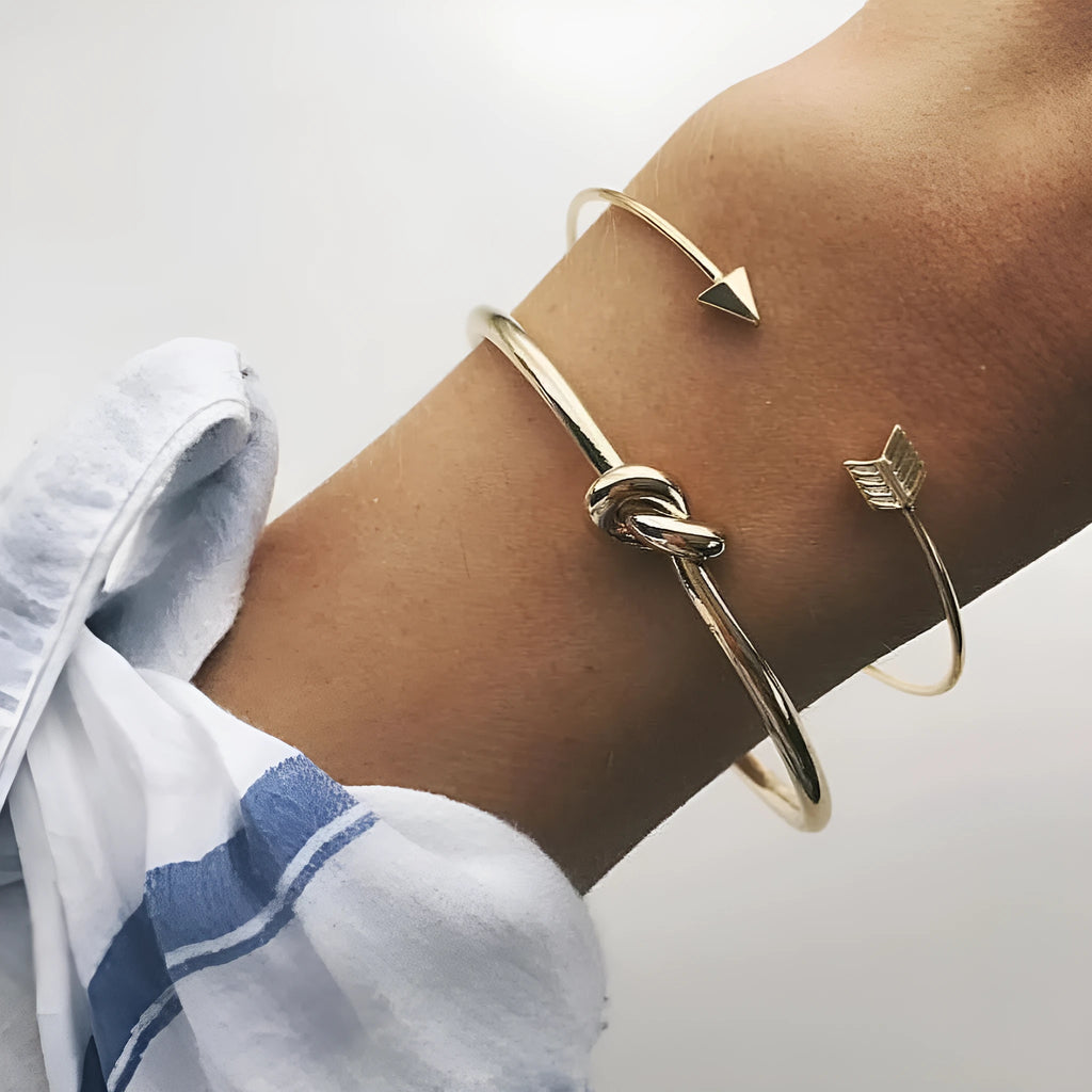 Gold-coloured women's vintage cuff bracelet with arrow and knot design in electroplated alloy