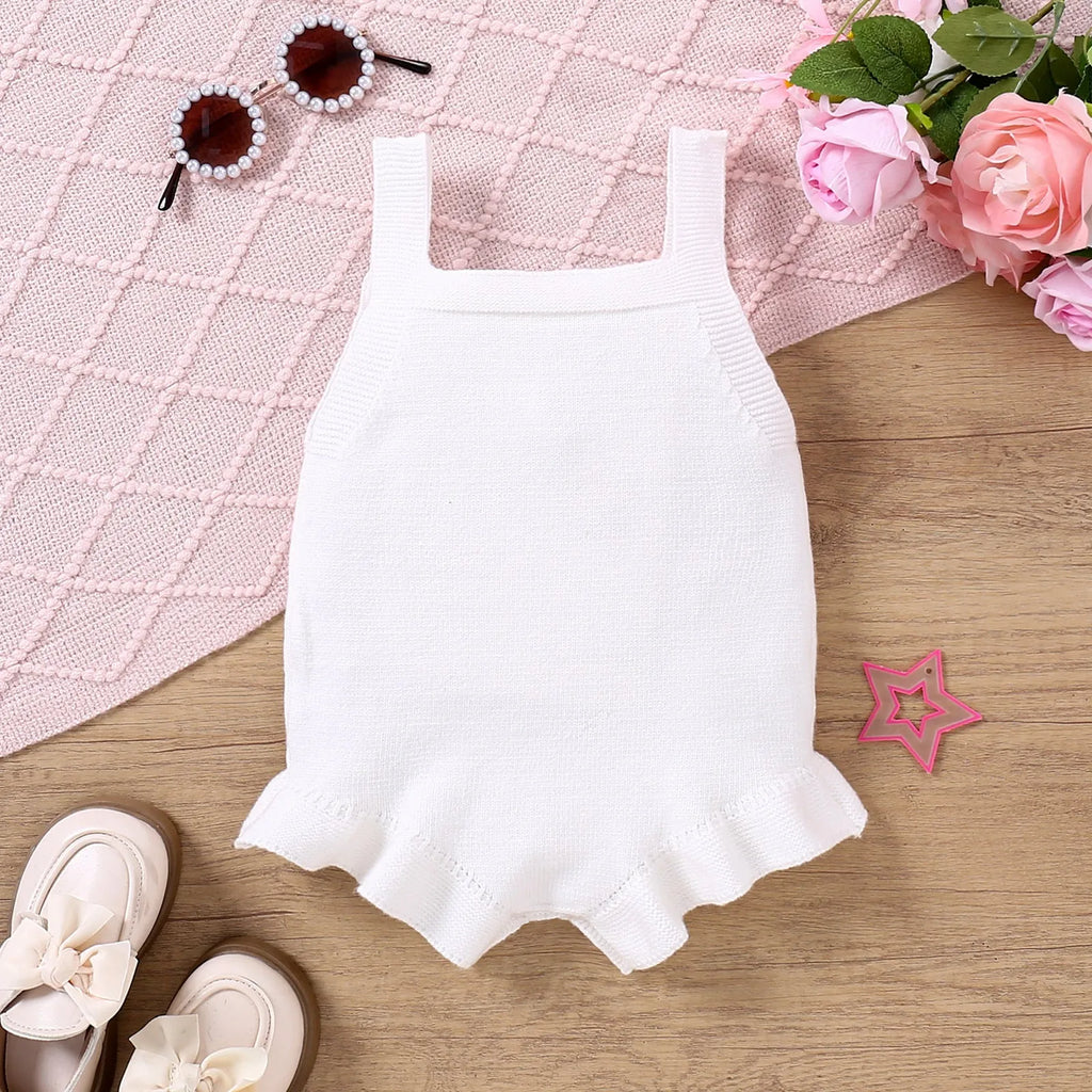 Baby sling-style wool blend romper with bow embroidery, in white or pink, sizes 0-3M to 12-18M
