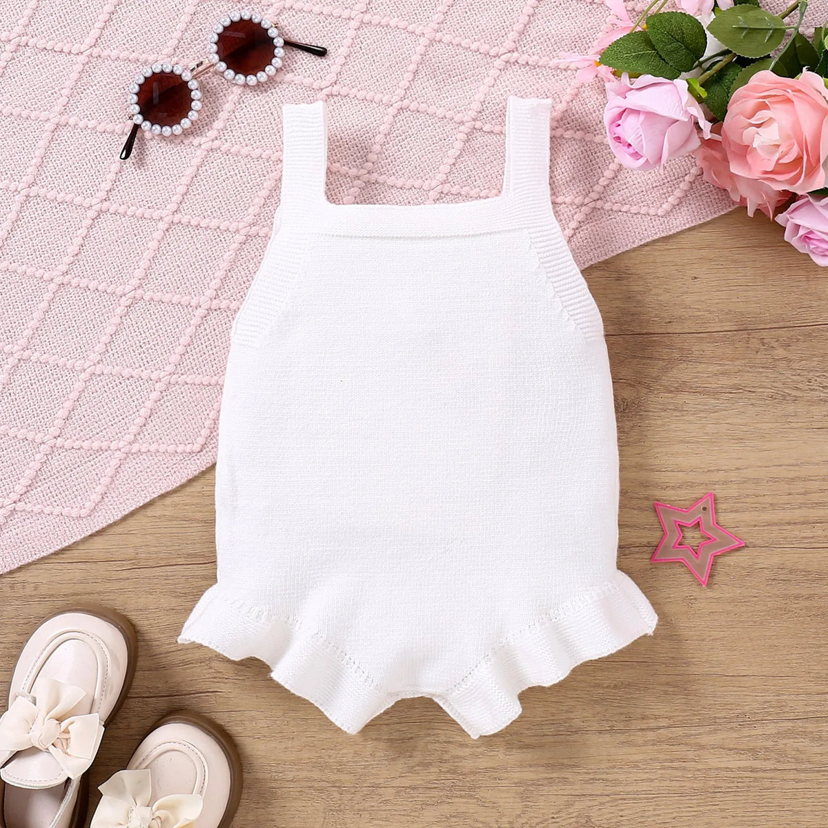 Baby sling-style wool blend romper with bow embroidery, in white or pink, sizes 0-3M to 12-18M