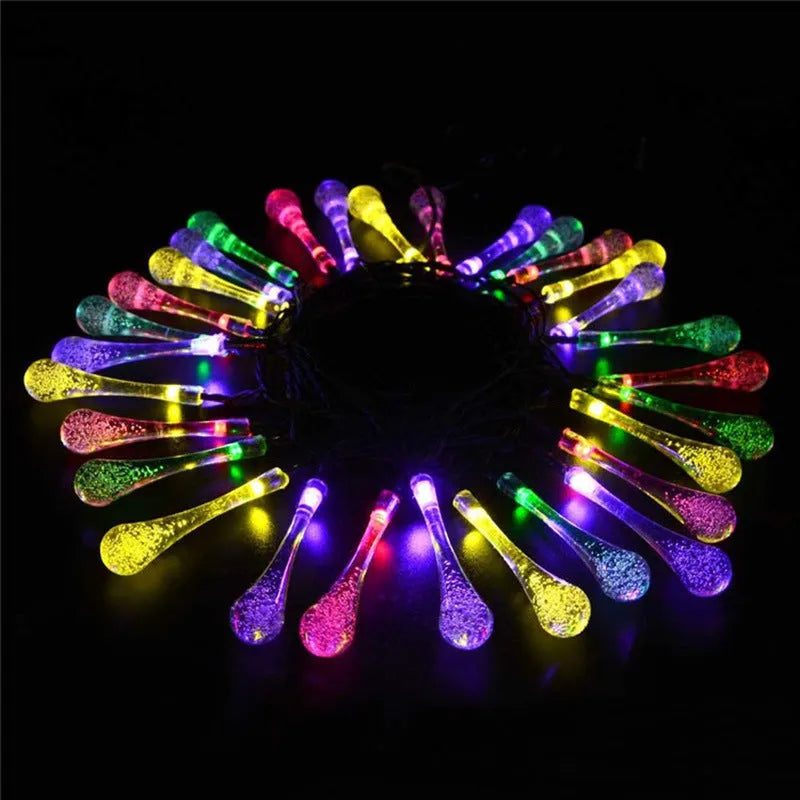Solar-powered outdoor string lights with water drop shaped pendants on a 6.5 metre cable.