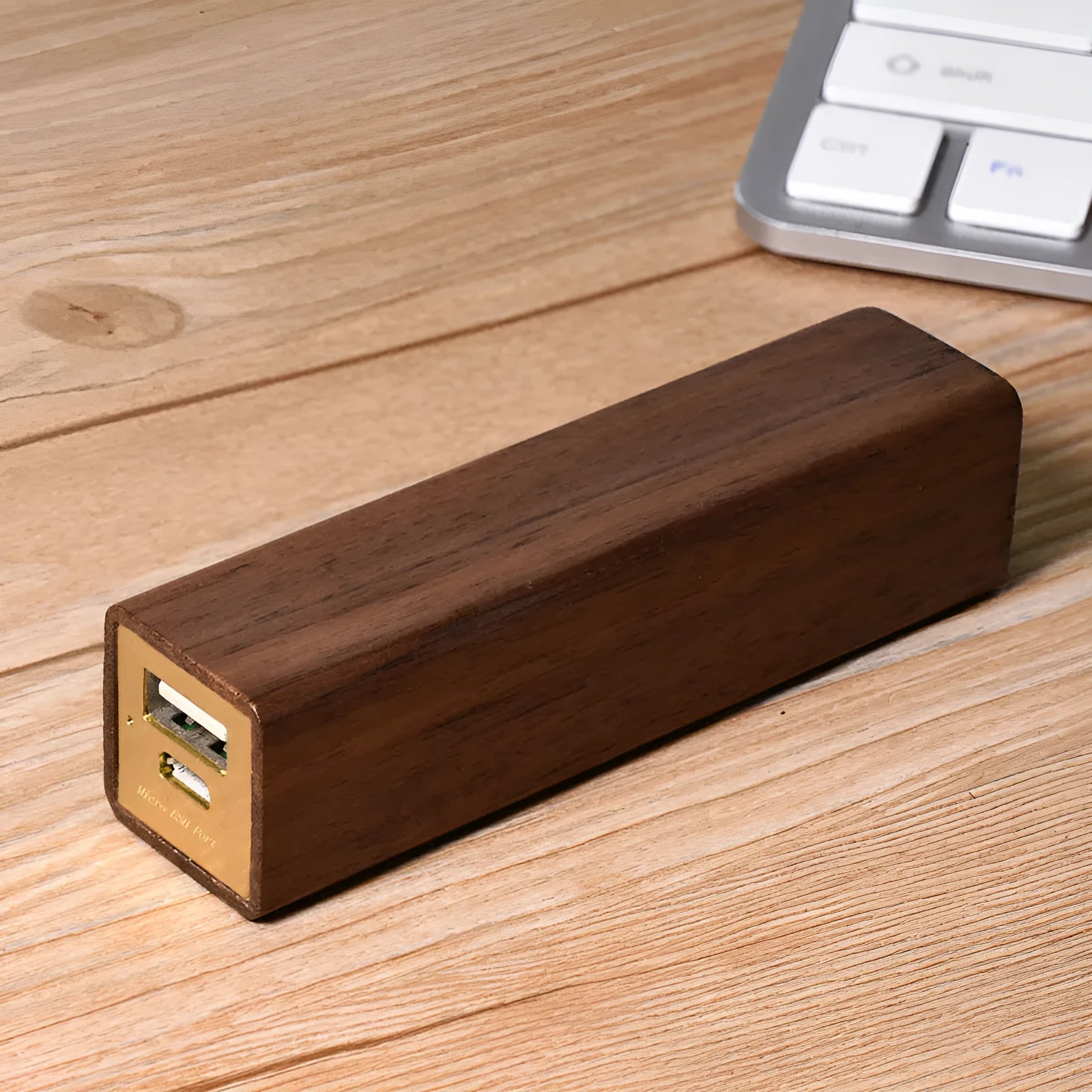 Brown walnut wood portable power bank with 2000mAh capacity and gift box packaging.