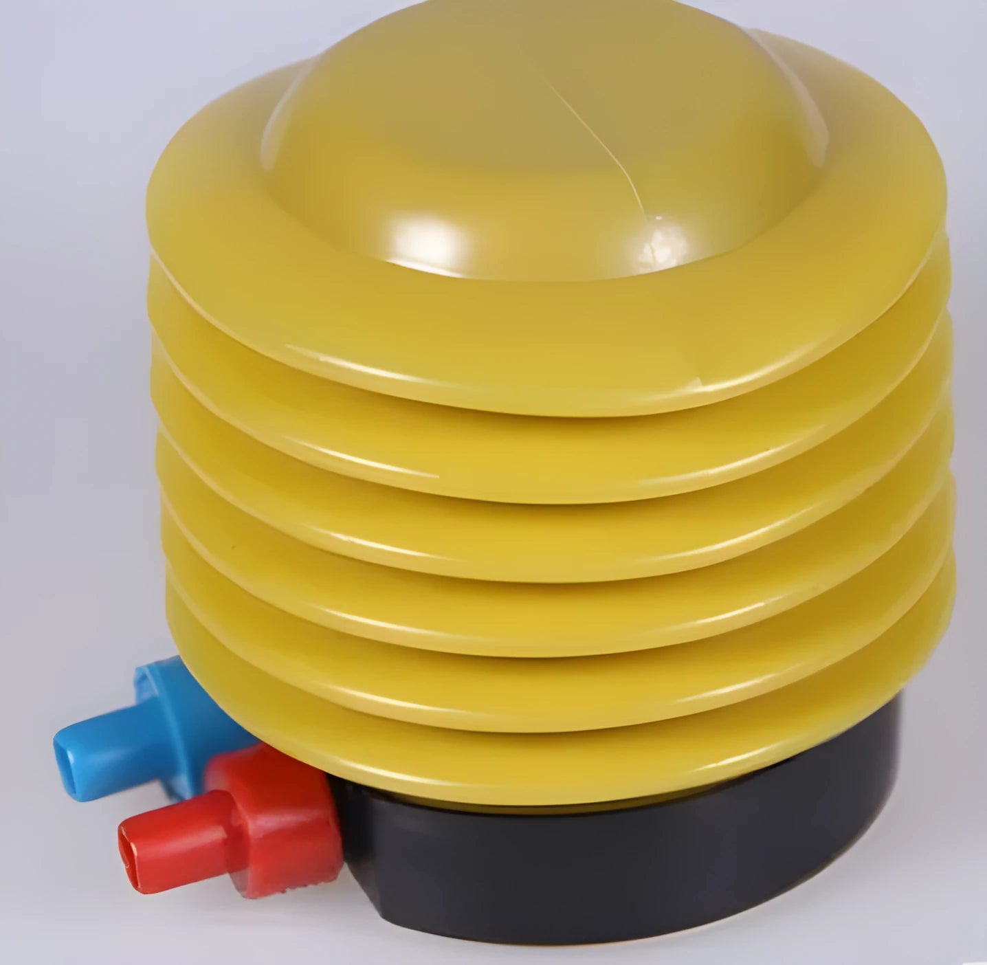 Blue and red manual pedal inflating pump for swim rings on a white background