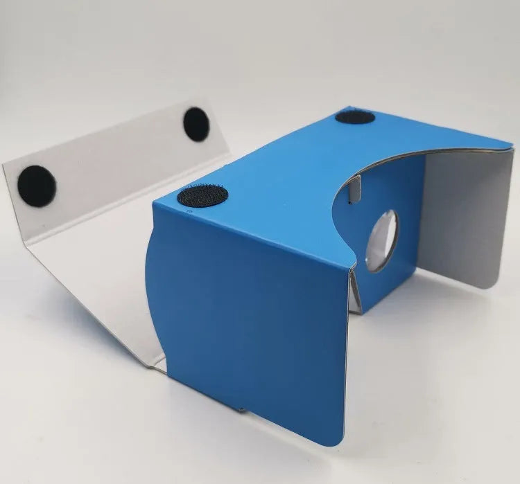Pink and white VR Cardboard Glasses headset for 6-inch smartphones on a table.