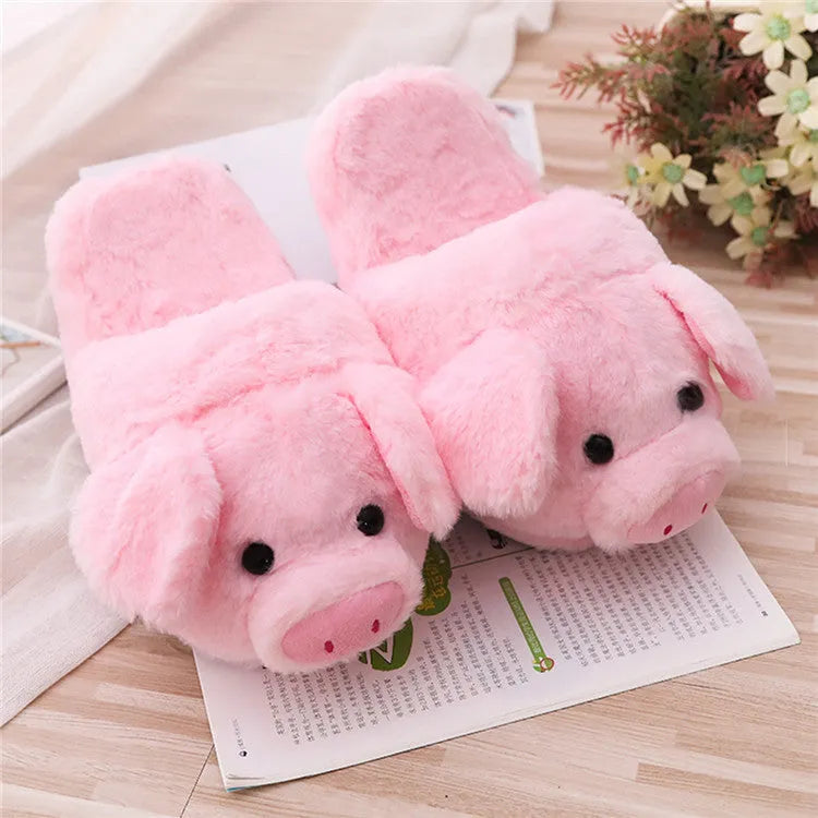Pink pig-themed plush floor slippers for adults on a plain background.