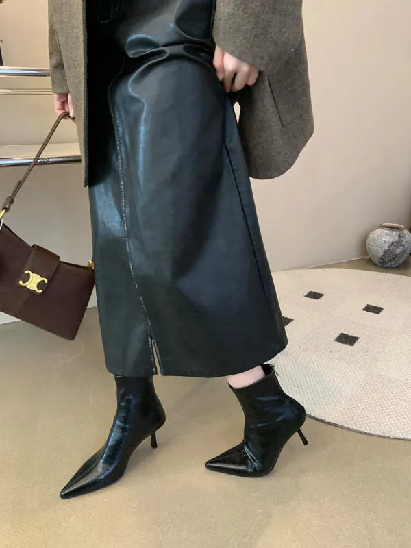 Stiletto heel ankle boots in black faux leather with pointed toe, tassel detail and back zipper, sizes 35-40