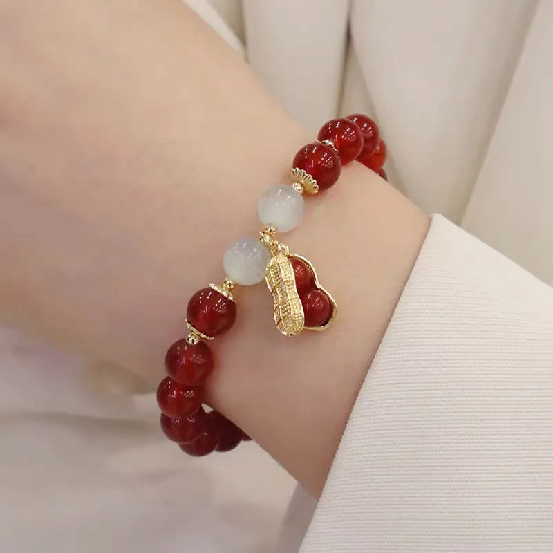 Chinese style glass bead bracelet with bamboo leaf design and manual craftsmanship details.