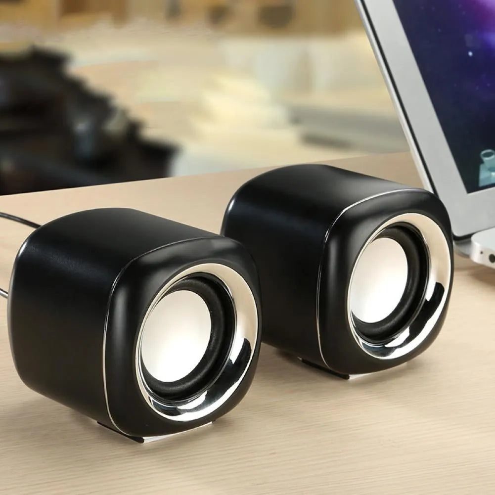 Compact black wired desktop speaker pair with 3.5mm plug measuring 7.2cm