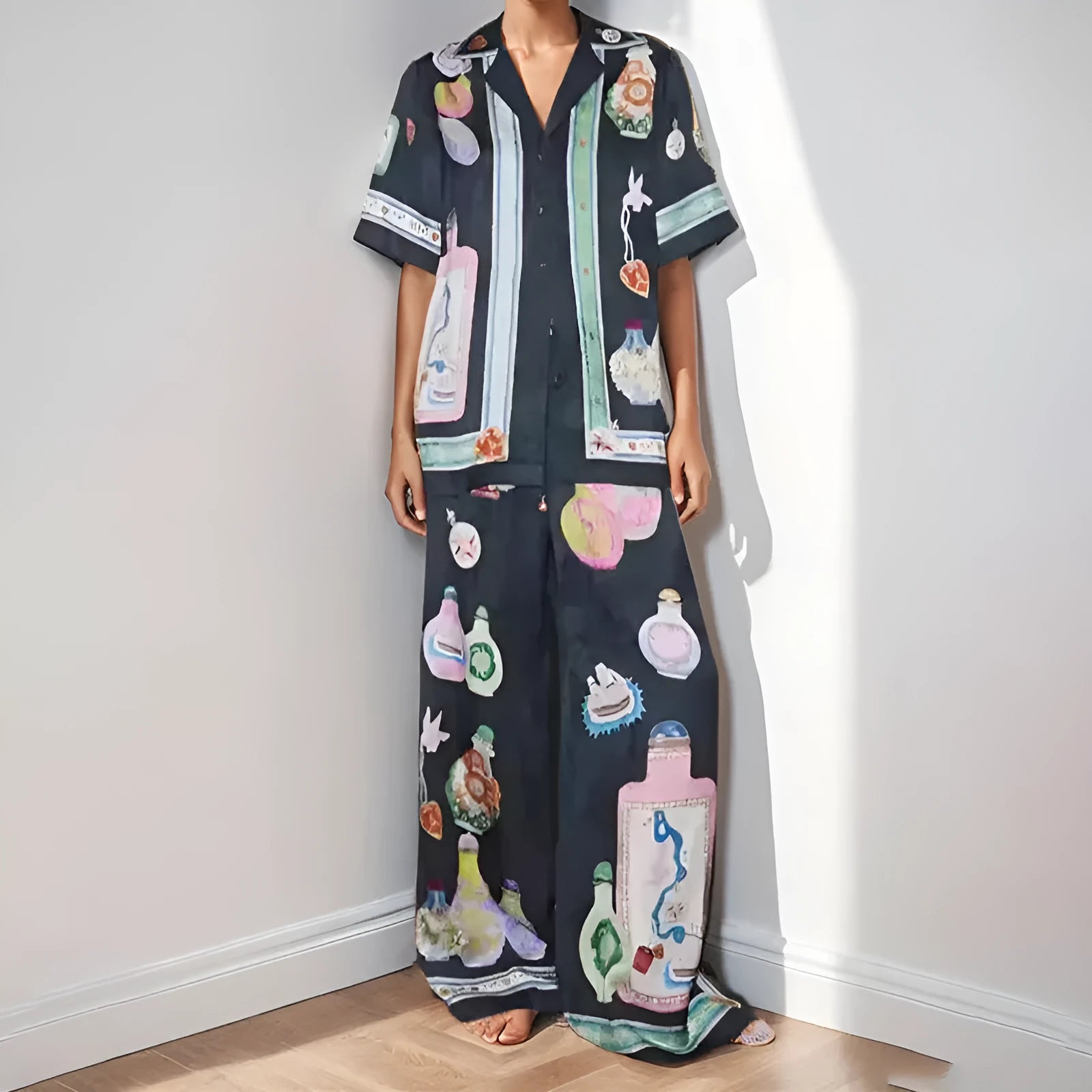 Black women's casual set with anime cartoon print, featuring a long sleeve cardigan and matching trousers.