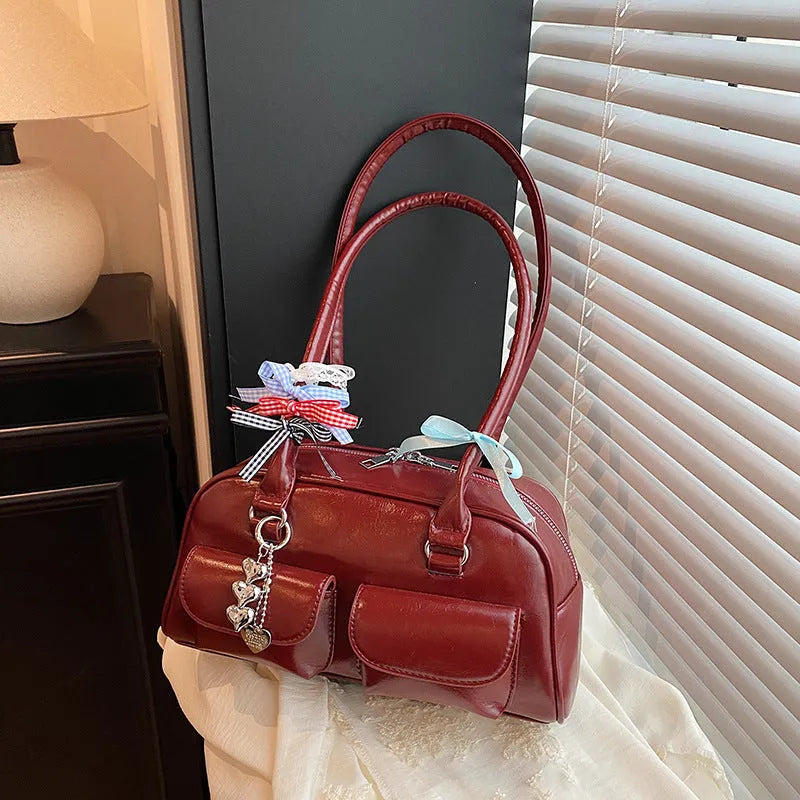 Retro brown PU leather pillow-shaped women's shoulder bag with double straps and a flap closure.