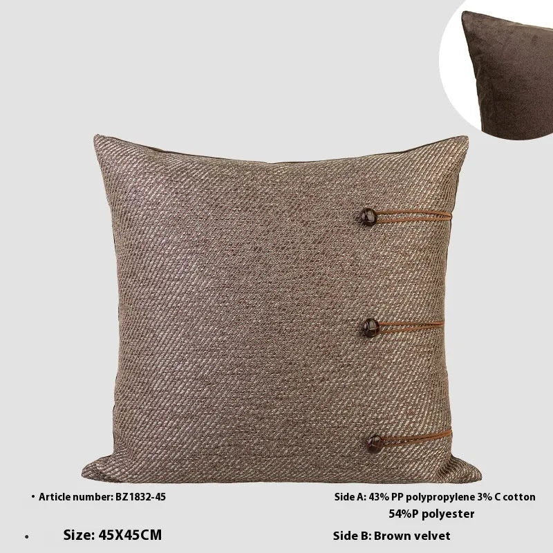 Chinese style square cushion with geometric pattern in Maillard brown colour on a sofa.