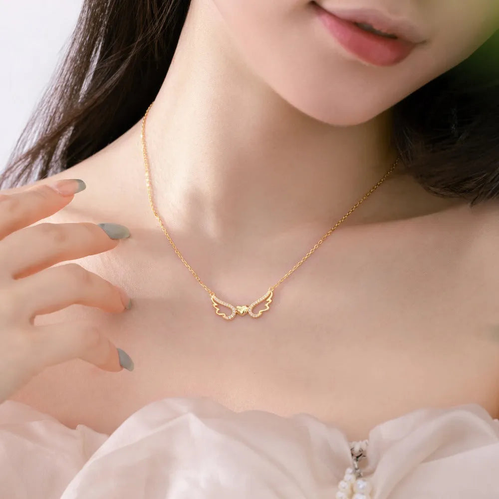Women's 925 silver hollow-out wings love necklace on display