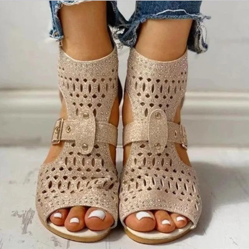Women's beige flat sandals with back zipper and fish mouth toe on wedge heel.