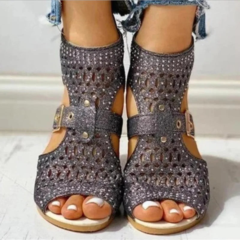 Women's beige flat sandals with back zipper and fish mouth toe on wedge heel.