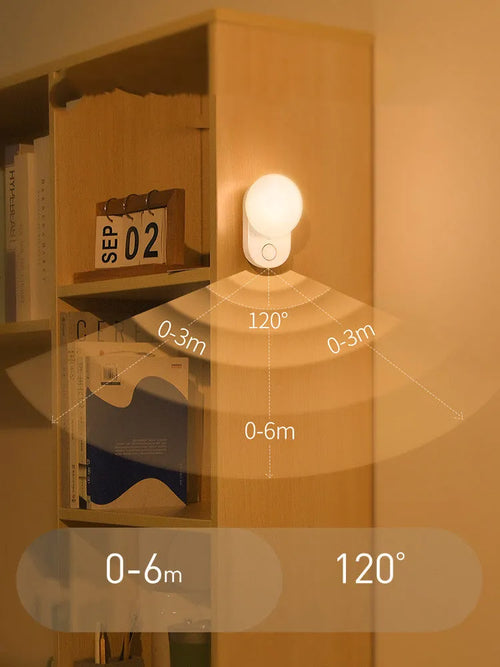 Baseus Sunshine Series white rechargeable motion sensor night light on a bedside table.